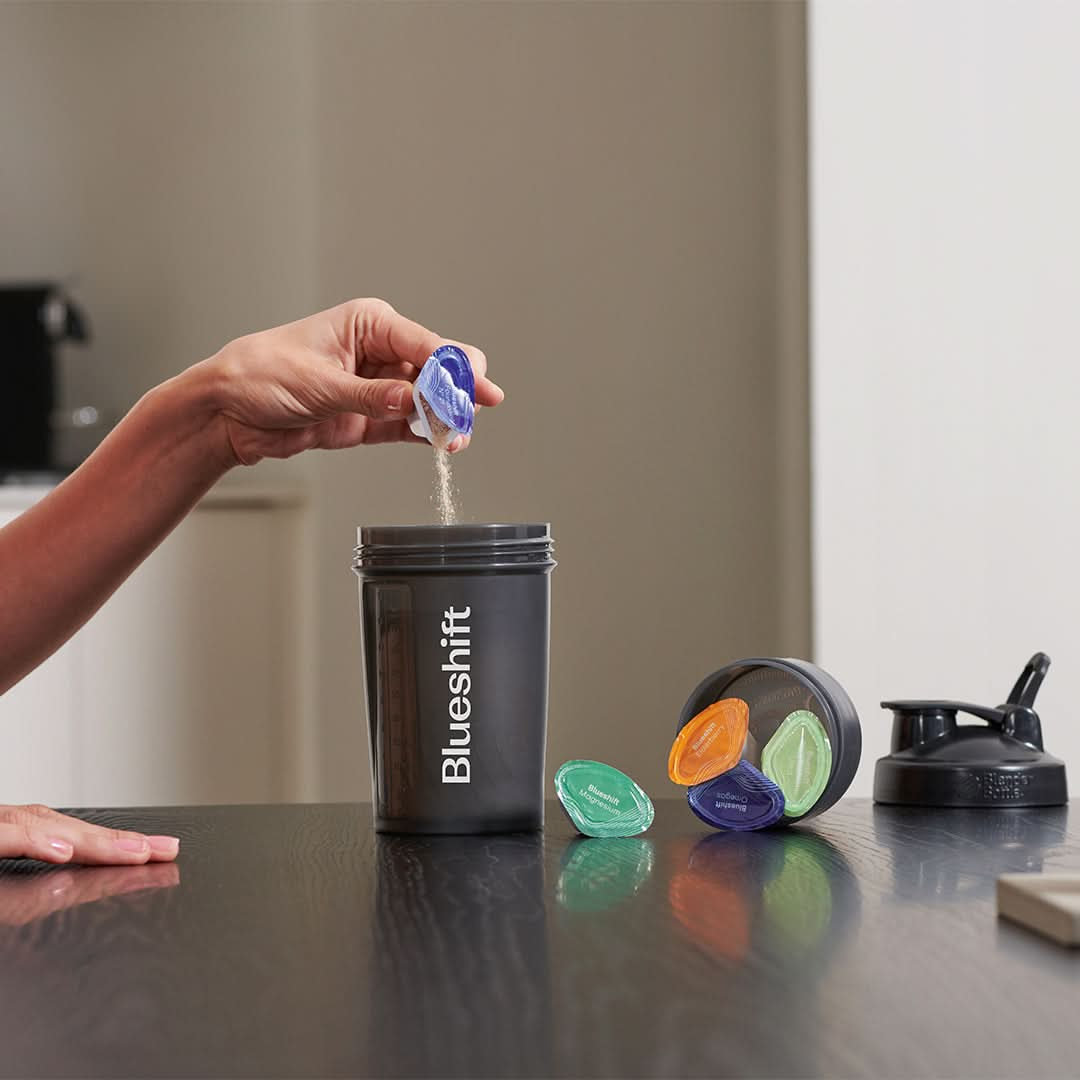 https://www.blueshiftnutrition.com/cdn/shop/products/blueshift-blender-bottle-pouring-pods.jpg?v=1672418027